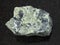 rough serpentinite stone on dark background