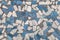 Rough simple mosaic of split tiles in white and blue shades texture background