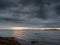 Rough stone coast of Galway bay Ireland at blue hour. Burren mountains in the background. Calm and peaceful mood. Irish landscape