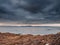 Rough stone coast of Galway bay Ireland at blue hour. Burren mountains in the background. Calm and peaceful mood. Irish landscape