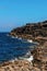 Rough stone coastline of Ireland, Burren area. Blue sky and ocean water. Vertical image. Irish landscape. Nobody