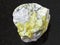 rough sulfur ore on dark background