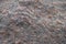 Rough surface of pink granite stone