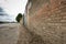 Rough textured surface of a weathered brick wall at a livery yard.