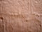 Rough uneven terracotta colored cement wall background with paint brush marks texture