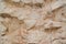 A rough untreated surface is a natural stone surface. The texture of the natural rock is the background. Granite or cracked marble