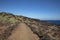 Rough volcanic path crossing the badlands known as Malpais de Guimar near Puertito de Guimar in Tenerife, Canary Islands