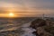 Rough weather off the lighthouse at sunset Isle of Anglesey North Wales