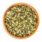 Roughly chopped raw pepita pumpkin seeds in wooden bowl over white