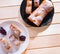 Roulade with apples, strudel on a white and black and white plate on a wooden background