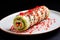 roulade of raw cookie dough with red and green sprinkles on top