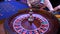 Roulette wheel running in a casino, poker chips. Classic casino roulette wheel