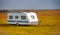 Roulotte on the countryside of Iceland, summer season, white caravan in autumn season