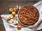 Round apple pie or biscuit on a white napkin with fresh pears on a wooden table