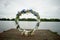 Round arch with white and blue flowers. Check-out on the river or lake.Wedding registration.