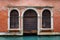 Round arched entrance of a venetian building on a canal in Venice, Italy