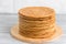 Round baked cake layers stacked on  plate. Cooking honey cake at home