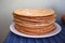 Round baked cake layers stacked on a plate. Homemade cakes.