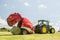 A round baler discharges a hay bale during harvesting