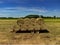 Round bay bales piled on a trailer ready for collection in the English countryside farmland