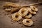 Round biscuits and bread spikes on a background of coarse cloth