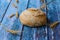 Round bread on rustic background. Wheat ears, spikelets, awns, grains.