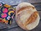 round bread top view. Delicious fresh cornbread with sprinkles on an old wooden table and a beautiful traditional towel