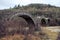 Round bridges cross a river in zagorohoria greece