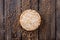 Round buckwheat crispbread on wooden vintage textural background with scattered buckwheat