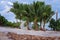 Round Cabana Under Palm Trees On A Sandy Beach
