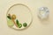 A round ceramic dishes containing slices of lime and kumquat, green leaves and dried cinnamon stick decorated