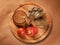 Round cheese, sliced bread and tomatoes on round wooden board to