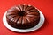 Round chocolate cake with cream and chocolate shavings