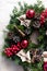 Round Christmas wreath with red baubles and berries