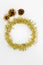 Round circle of tinsel, three bumps. Christmas decorations of yellow and golden color on a white background. New year