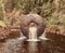 Round circular sculpture in a flowing water fountain in Eidsvoll, Norway