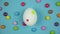 Round colored candies move near egg and paint it in the Easter egg. Stop motion animation