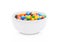 Round colorful coated sweet candies in white bowl
