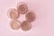 Round composition of candlesticks in rose gold on a pink background. top view, copy space