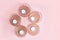 Round composition of candlesticks in rose gold and white candles on a pink background. flat lay, copy space