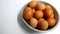 Round container containing fresh chicken eggs. Chicken eggs on a white background. Selective focus.