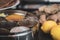 A round container for spices - with ginger and roti - cooking Indian food.