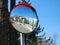 Round convex traffic mirror on the alley for better visibility. Convex mirrors provide a wider field of view on roads