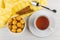 Round cookies in bowl, cinnamon on napkin, cup of tea