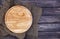 Round cutting board on old wooden texture background. Top view