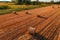 Round cylinder shaped hay bales in cultivated wheat field after crop harvest, high angle view