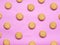 Round Danish butter cookie on pink background.