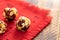 Round energy balls handmade from is lying on red napkin on wooden table.