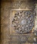 Round floral patterns framed by geometrical patterns carved into the exterior wall of Sultan Hasan Mosque, Cairo, Egypt