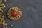 Round form made of gold pop rivet nuts ond lochnuts with red christmas ball on it on black tectured chalk board
